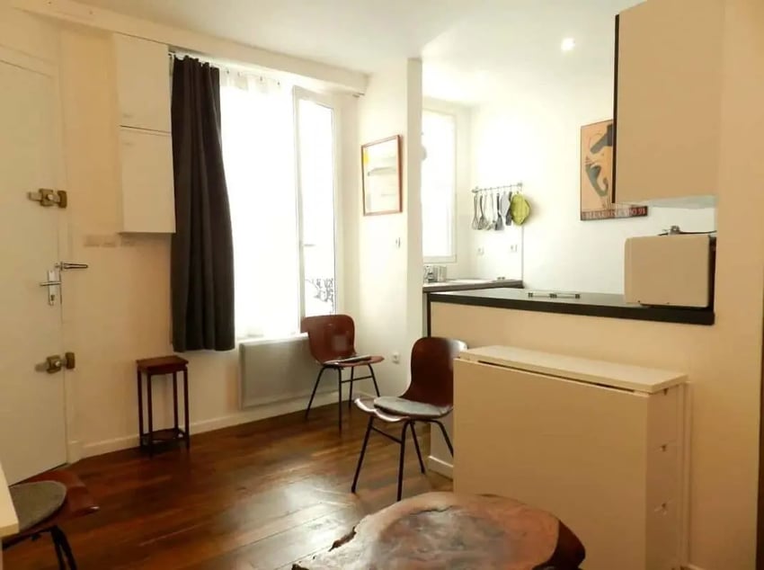 Chairs small table and kitchen counter living room at Apartment 1 bedroom 28m² in Paris Student Accommodation