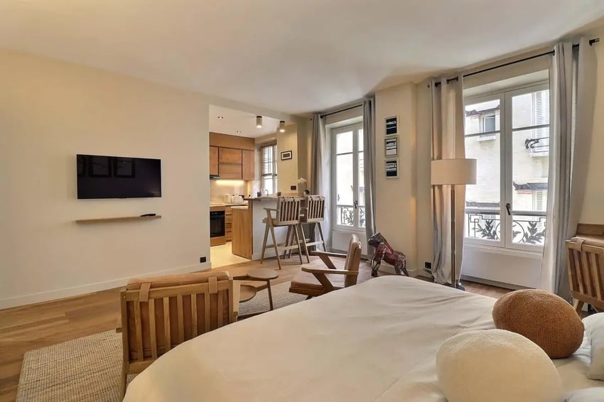 Bed kitchen bar stools tv living room at Apartment Studio 38m² in Paris Student Accommodation