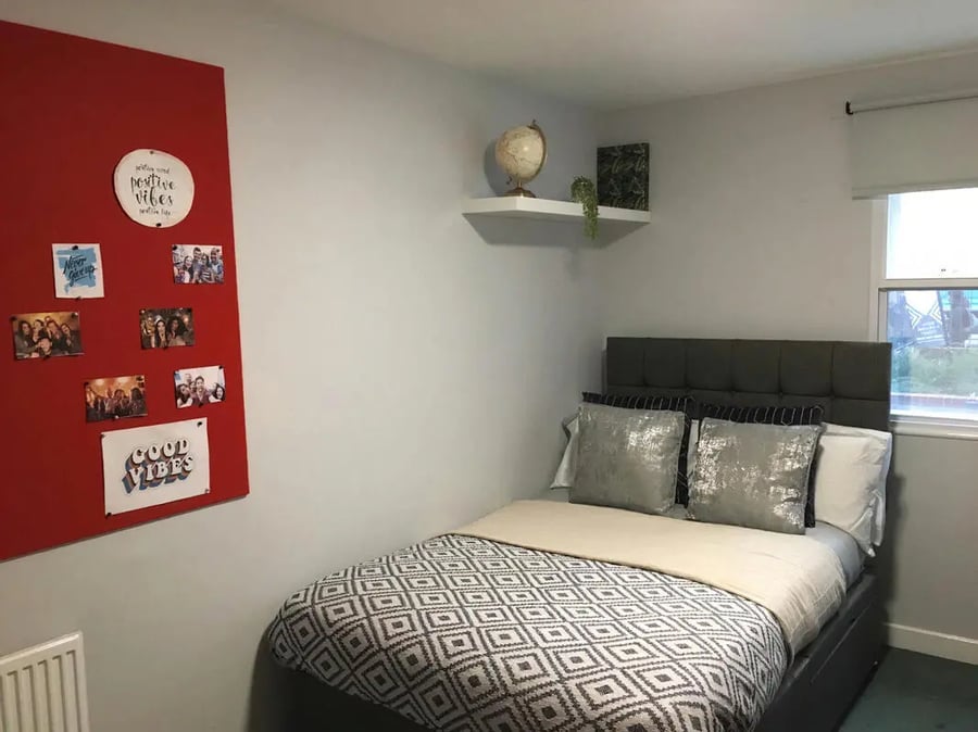 Red pin board photos globe shelf bed Bedroom at Dean House in London Student Accommodation