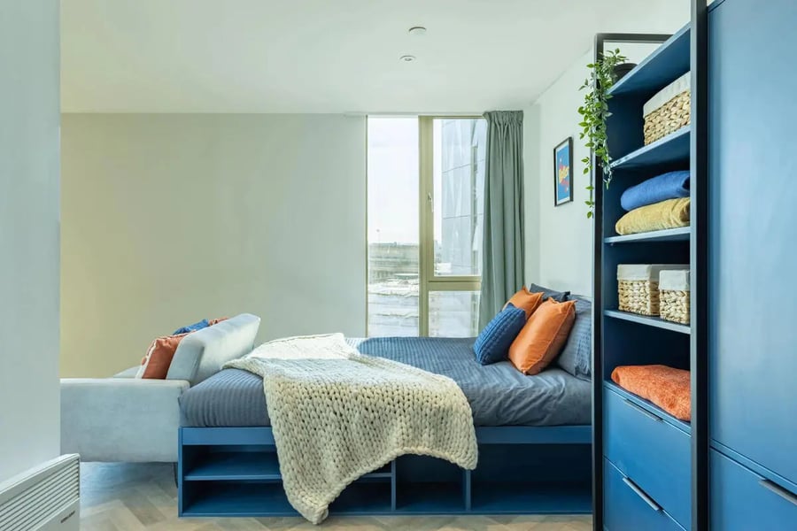 Bed with blue frame and storage bedroom at Limelight in Liverpool Student Accommodation