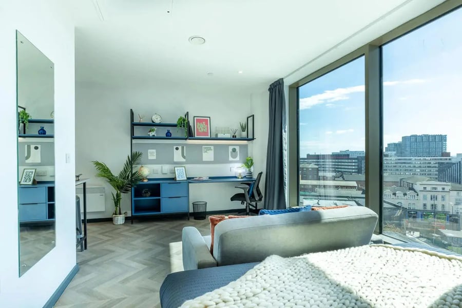 Desk couch mirror shelving unit and city view interior at Limelight in Liverpool Student Accommodation