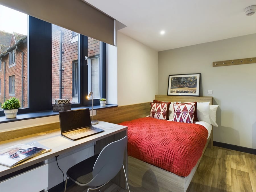 Desk laptop chair red bed bedroom study area at Eden Square in Coventry Student Accommodation