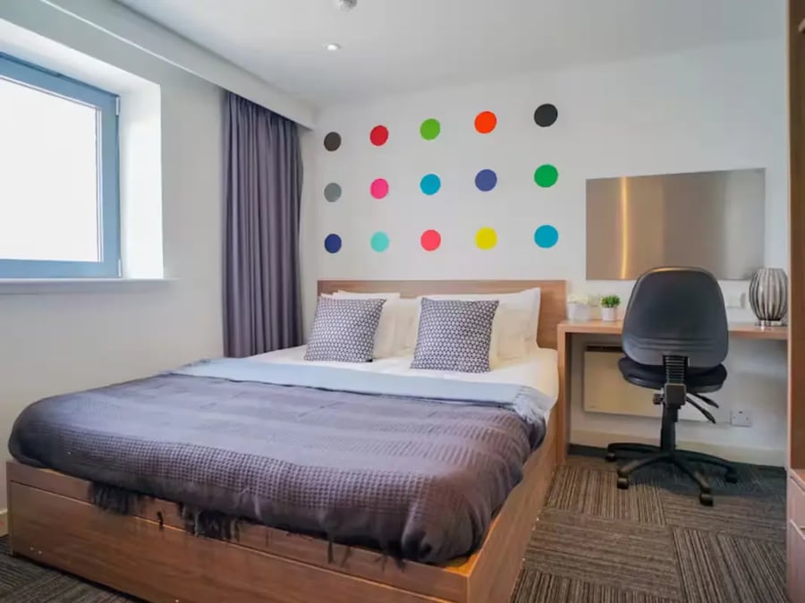 Bed desk chair colorful dots bedroom at Gallery Apartments in Glasgow Student Accommodation