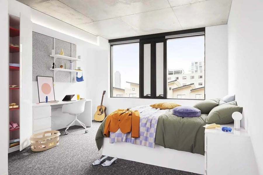 Bed desk guitar storage shelves bedroom at Scape Lincoln College in Melbourne Student Accommodation