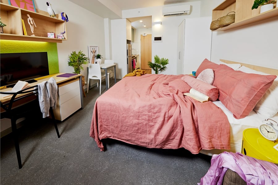 Bed desk plants shelves and table bedroom at Scape Sydney Central in Sydney Student Accommodation
