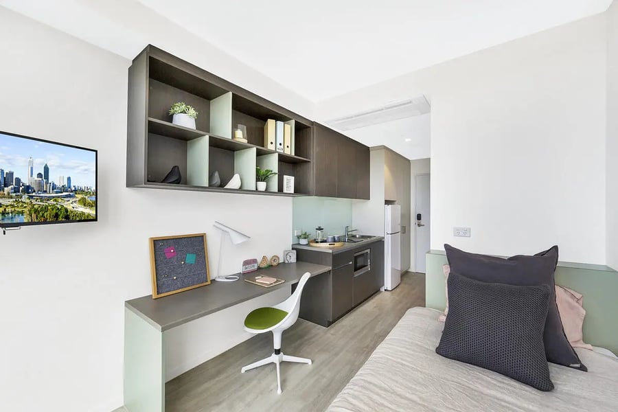 Desk television shelves kitchen and bed living room at Scape Merivale in Brisbane Student Accommodation