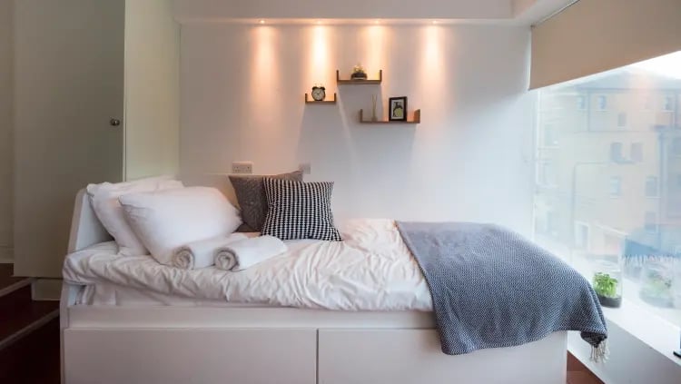 Bed with pillows towels and throw bedroom at The Stay Club - Camden in London Student Accommodation