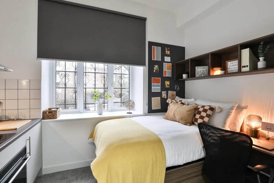 Bed desk and kitchen area bedroom at Francis Gardner in London Student Accommodation