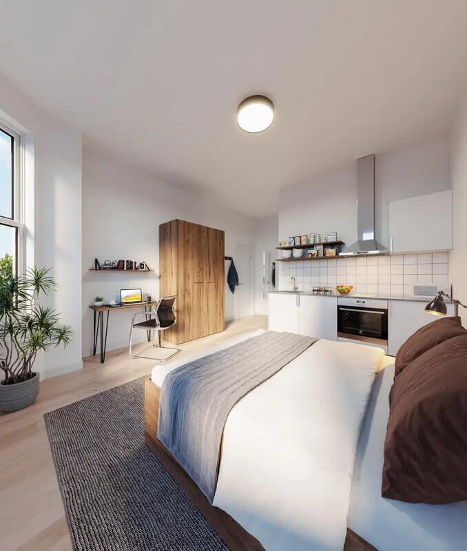 Bed desk wardrobe kitchen area studio apartment at Francis Gardner in London Student Accommodation
