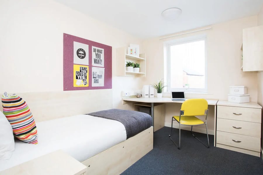 Bed desk chair laptop and posters bedroom at The Grange Leicester in Leicester Student Accommodation