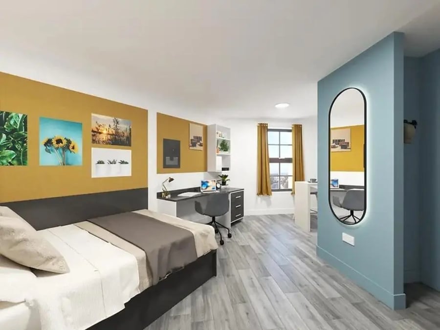 Bed desk chair and mirror bedroom at Depot Point in London Student Accommodation