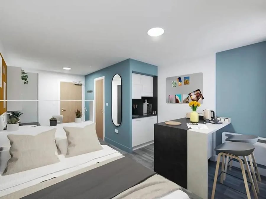 Bed kitchen counter and stools study area at Depot Point in London Student Accommodation
