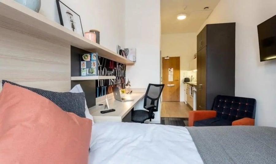 Bed desk chair kitchen and small sofa bedroom at The Arch - Liverpool in Liverpool Student Accommodation