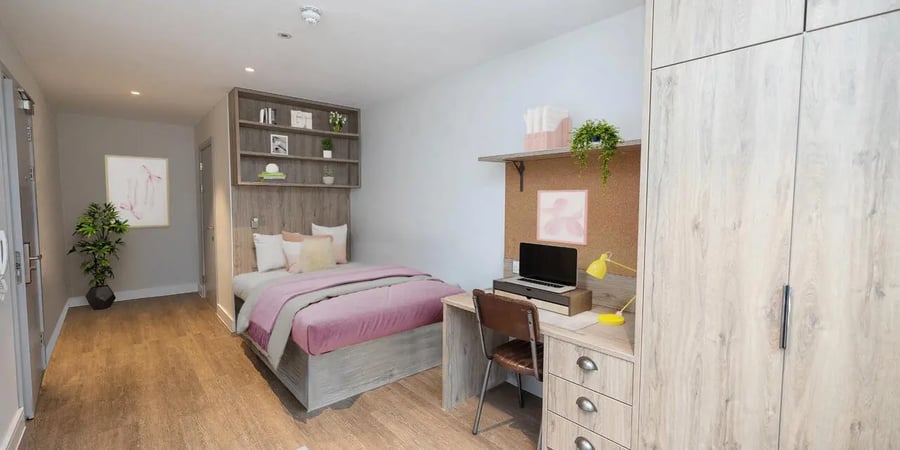 Bed desk wardrobe with wooden finishes bedroom at Canvas Student - Quintana Gate in Exeter Student Accommodation