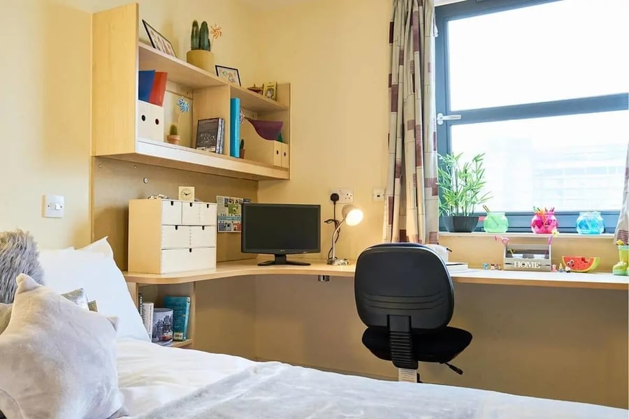 Desk with computer bed and shelves bedroom at Europa in Liverpool Student Accommodation