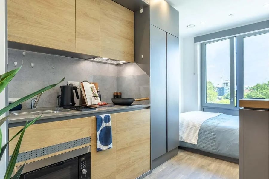 Compact kitchen with microwave bed and window bedroom at Great Court in London Student Accommodation
