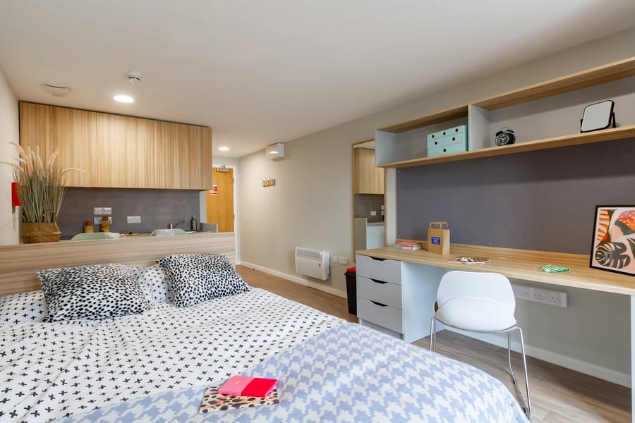 Bed desk chair and kitchen area studio at Gulson Gardens in Coventry Student Accommodation