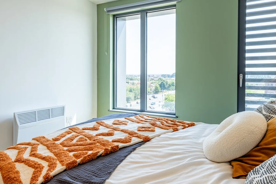 Bed with patterned throw heater and window bedroom at Winfield Court in Nottingham Student Accommodation