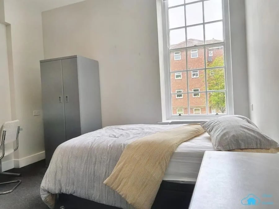 Bed wardrobe and chairs bedroom at St Mary's Newcastle in Newcastle Upon Tyne Student Accommodation