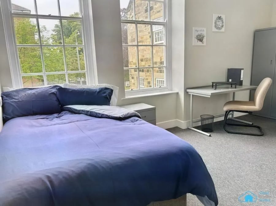 Blue duvet bed desk chair grey wardrobe bedroom at St Mary's Newcastle in Newcastle Upon Tyne Student Accommodation