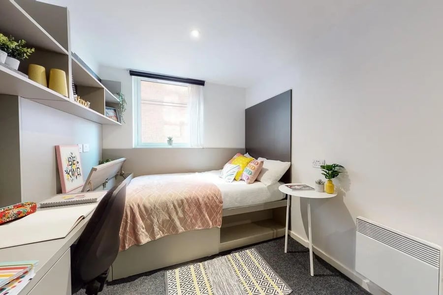 Bed desk shelves and rug bedroom at Canvas Coventry City Point in Coventry Student Accommodation