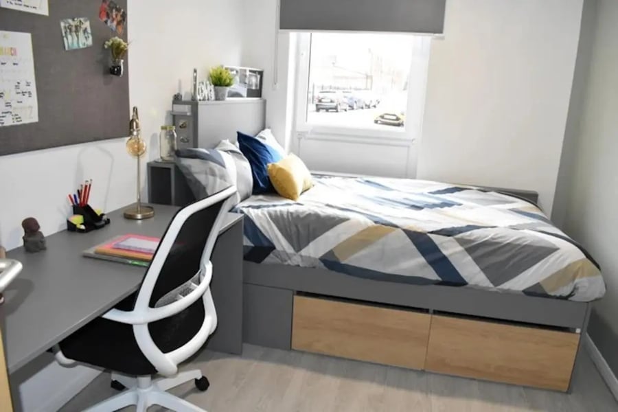 Desk chair bed with patterned bedding and window bedroom at Queens Court Leicester in Leicester Student Accommodation