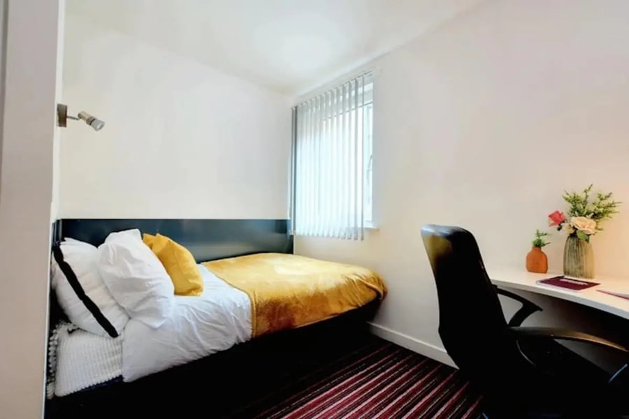 Bed desk chair and flowers Bedroom at Newarke Street Leicester in Leicester Student Accommodation