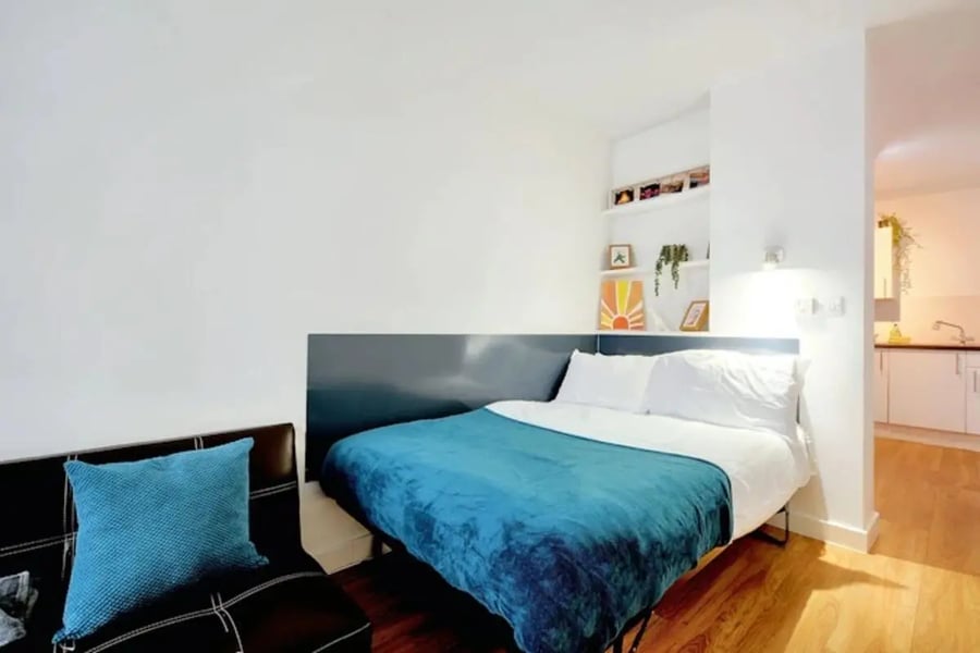 Bed couch and kitchen area bedroom at Newarke Street Leicester in Leicester Student Accommodation