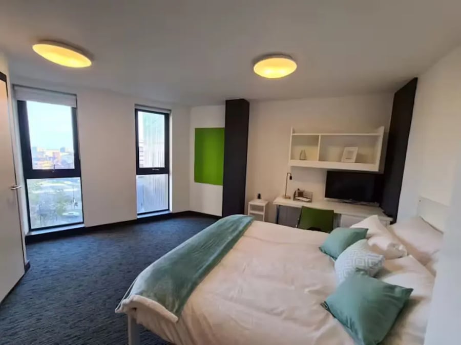 Bed desk shelves TV pillows bedroom at St James Point in Newcastle Upon Tyne Student Accommodation