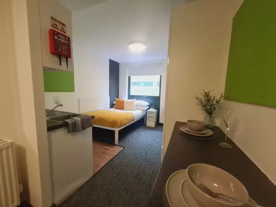 Bed with yellow throw sink fire blanket bedroom at St James Point in Newcastle Upon Tyne Student Accommodation