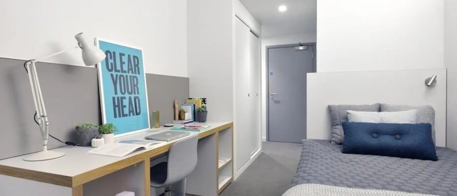 Desk lamp laptop and bed bedroom at Victoria Hall Kings Cross in London Student Accommodation