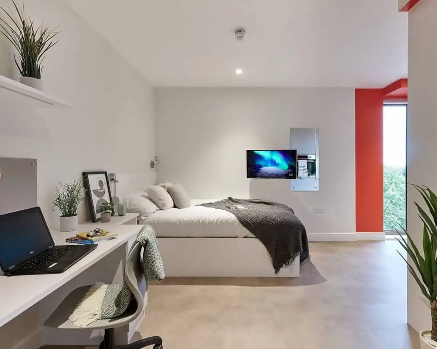 Bed desk laptop and TV Bedroom at Host View Studios in London Student Accommodation