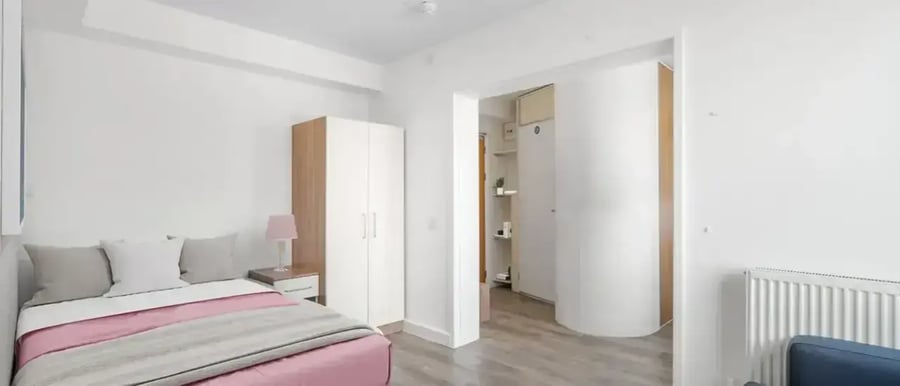 Bed wardrobe and nightstand with lamp bedroom at Chapter Highbury in London Student Accommodation