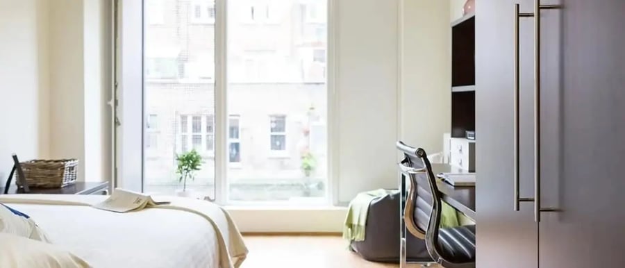 Bed desk chair and wardrobe bedroom at Chapter Portobello in London Student Accommodation