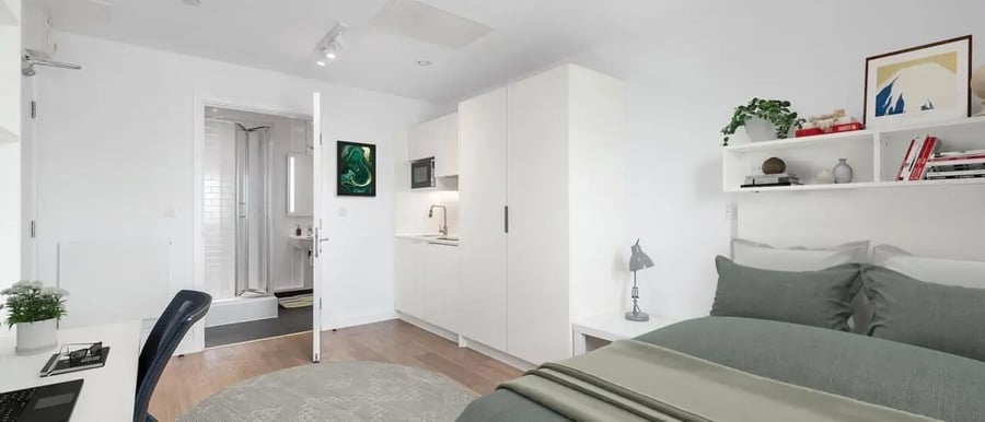 Bed desk kitchen bathroom shower visible student studio at Chapter Highbury II in London Student Accommodation