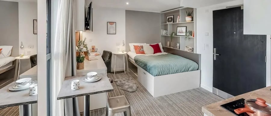 Bed desk shelves and door student studio at Chapter Ealing in London Student Accommodation