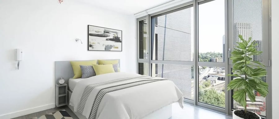 Bed alarm clock painting and plant bedroom at Chapter Lewisham in London Student Accommodation