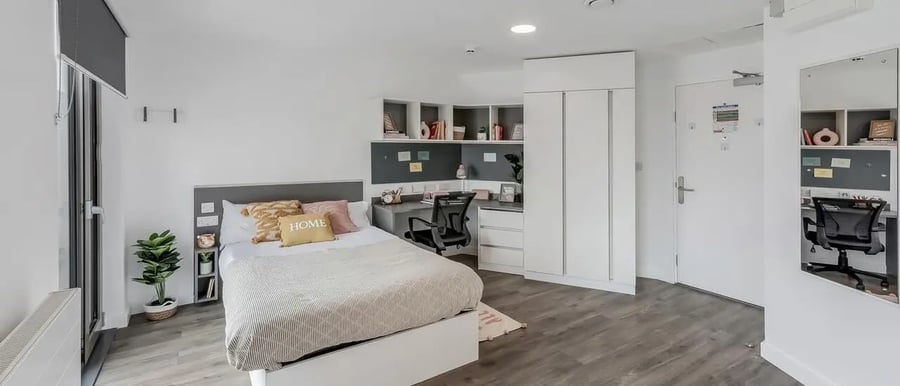 Bed desk plant wardrobe modern bedroom at Chapter White City in London Student Accommodation