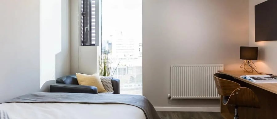 Bed chair desk lamp and radiator bedroom at Chapter South Bank in London Student Accommodation