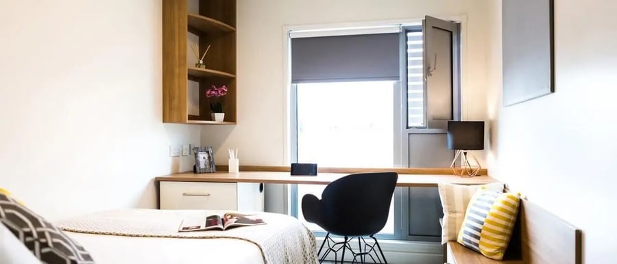 Bed desk chair shelves and window bedroom at Chapter South Bank in London Student Accommodation