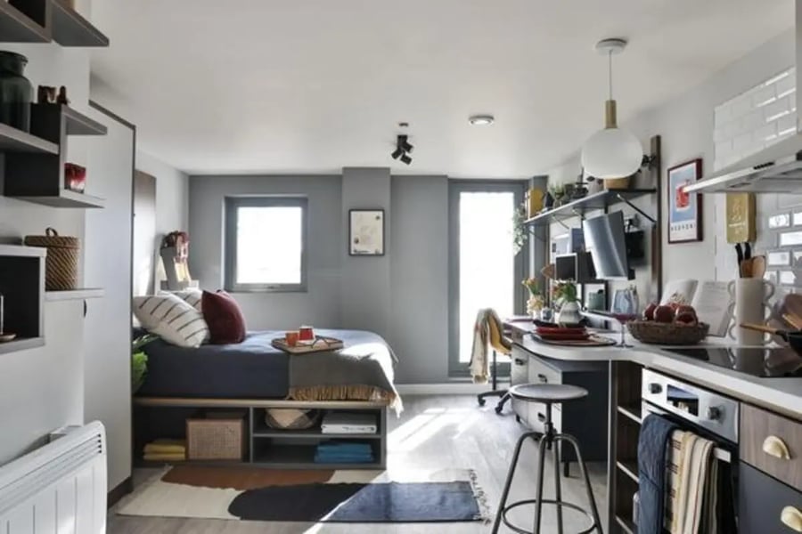 Bed desk kitchen storage and shelves studio apartment at The Hahnemann Building in Liverpool Student Accommodation