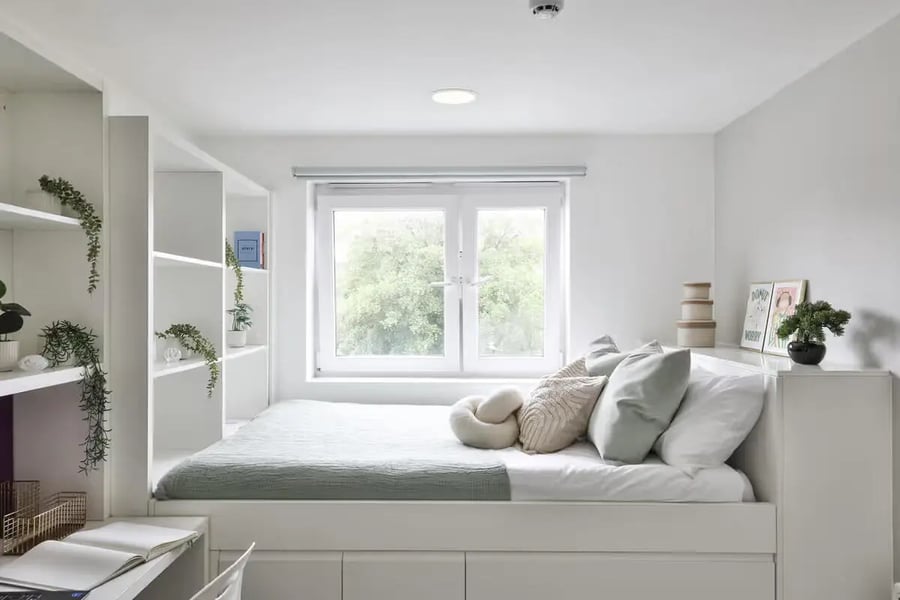 Bed with pillows shelves and window bedroom at Applegate Place in Leicester Student Accommodation