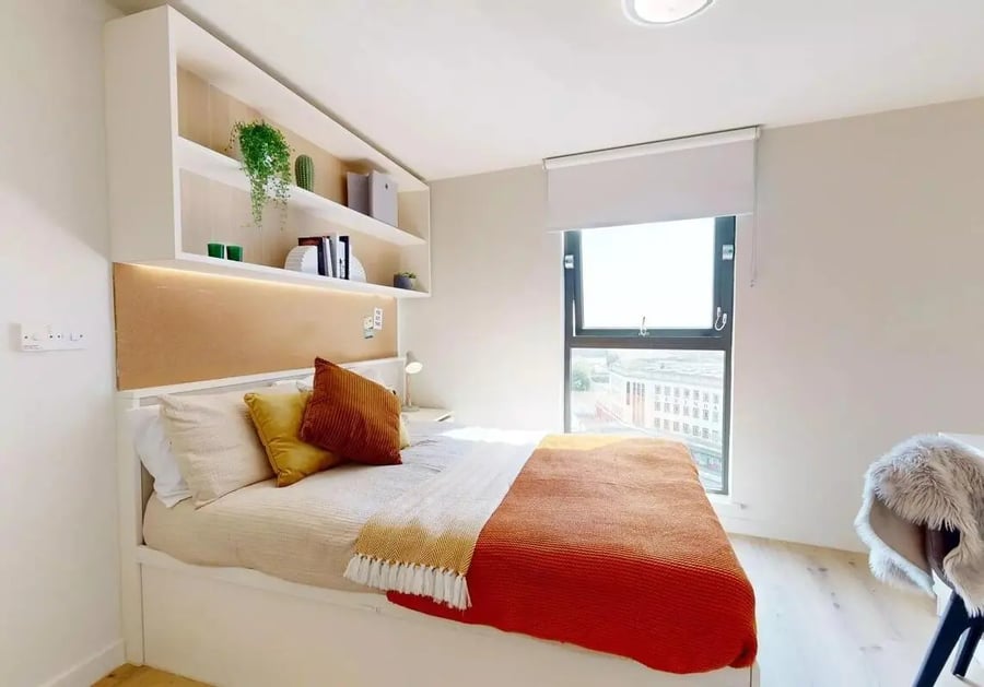 Bed with pillows shelves and window bedroom at iQ Bristol in Bristol Student Accommodation