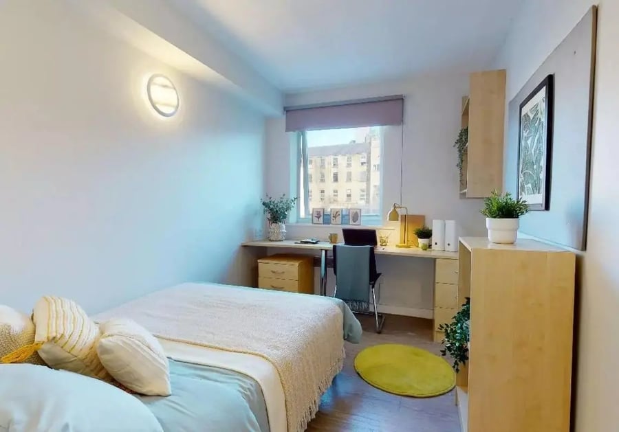 Bed desk chair rug and wall art bedroom at iQ Arkwright House in Bradford Student Accommodation