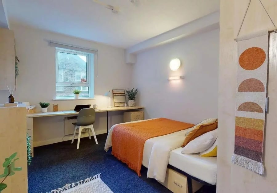 Bed desk chair and wall art bedroom at iQ Arkwright House in Bradford Student Accommodation