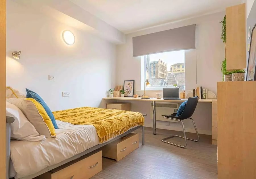 Bed desk chair laptop and window bedroom at iQ Arkwright House in Bradford Student Accommodation