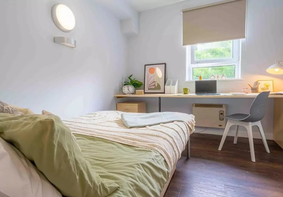 Bed desk laptop chair heater window bedroom at iQ Arkwright House in Bradford Student Accommodation