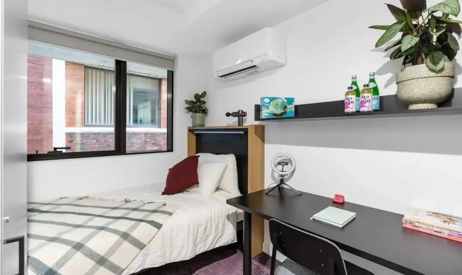 Bed desk air conditioner and window bedroom at The Switch Melbourne Victoria Market in Melbourne Student Accommodation