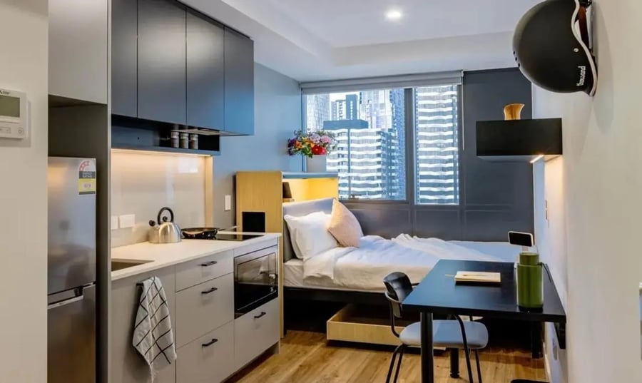 Bed kitchen table and chairs studio apartment at The Switch Melbourne Victoria Market in Melbourne Student Accommodation