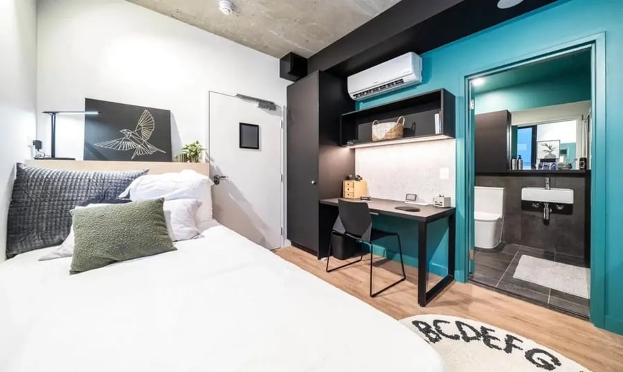 Bed desk air conditioner and bathroom bedroom at Perth Central in Perth Student Accommodation